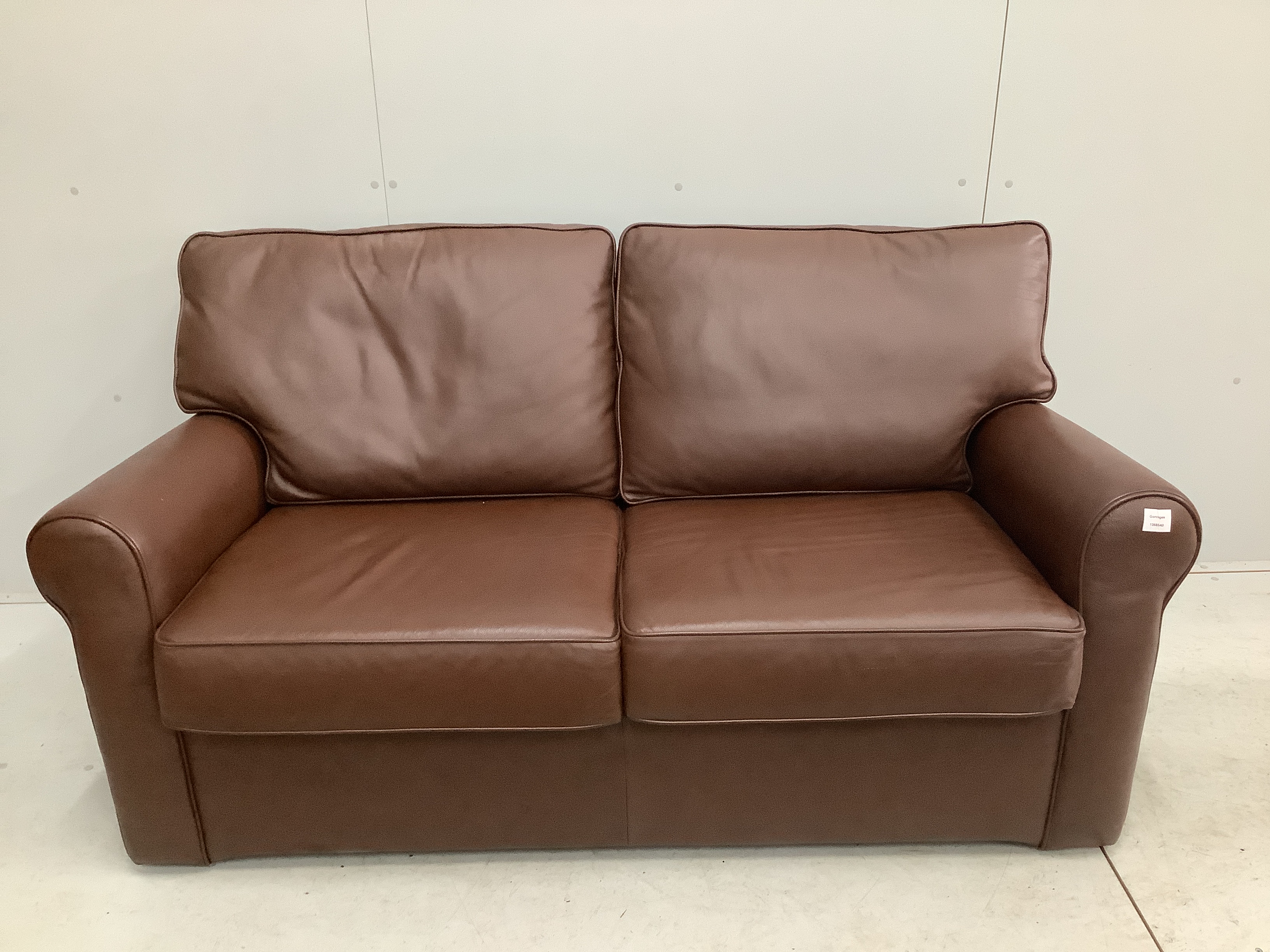 A modern brown leather two seater sofa bed, width 160cm, depth 80cm, height 86cm